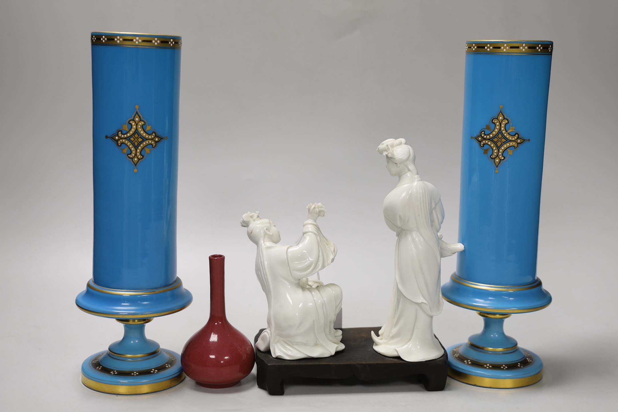 A pair of French enamelled glass vases, two Chinese blanc de chine figures on a stand and a miniature bottle vase, tallest 19cm high